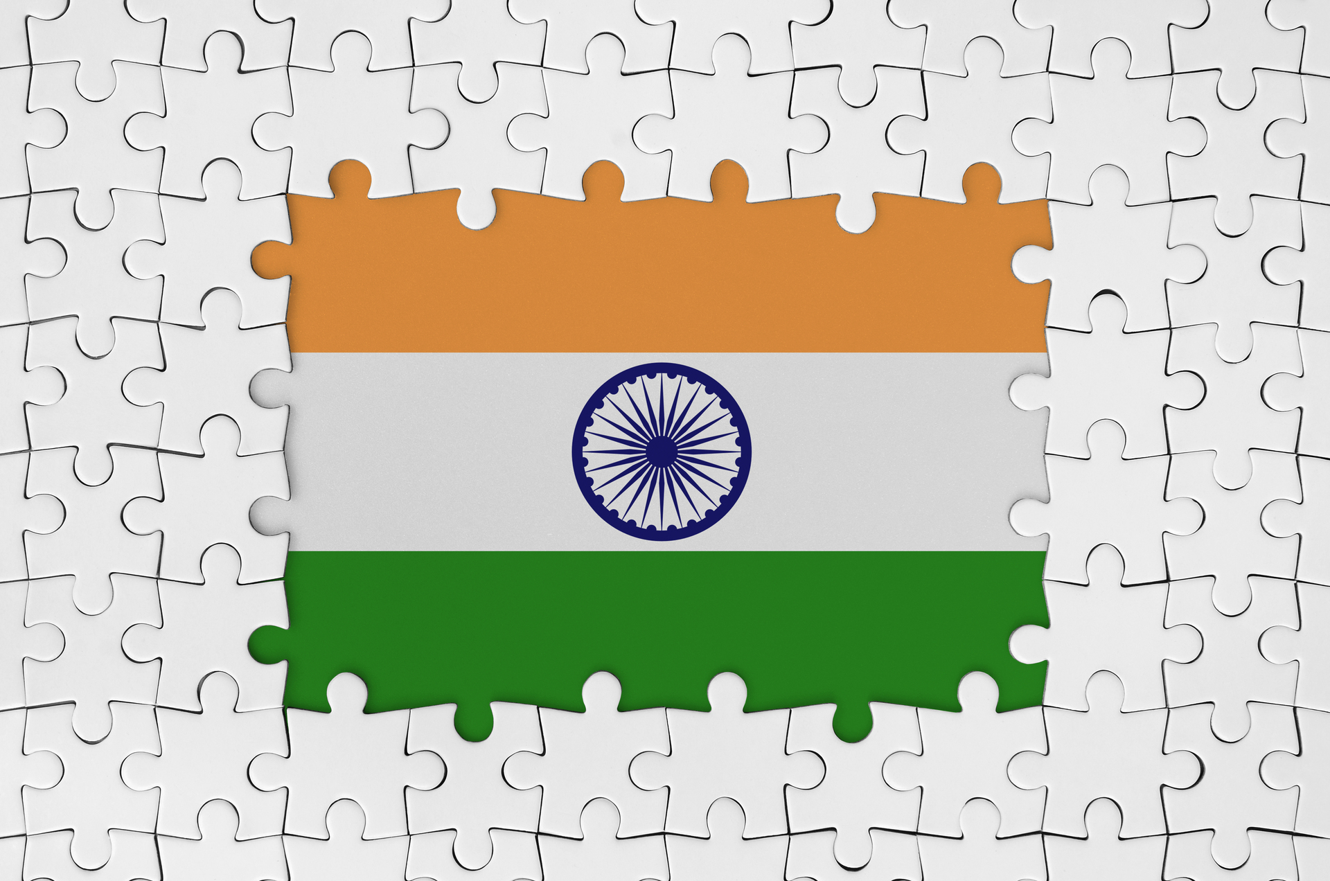India flag in frame of white puzzle pieces with missing central part